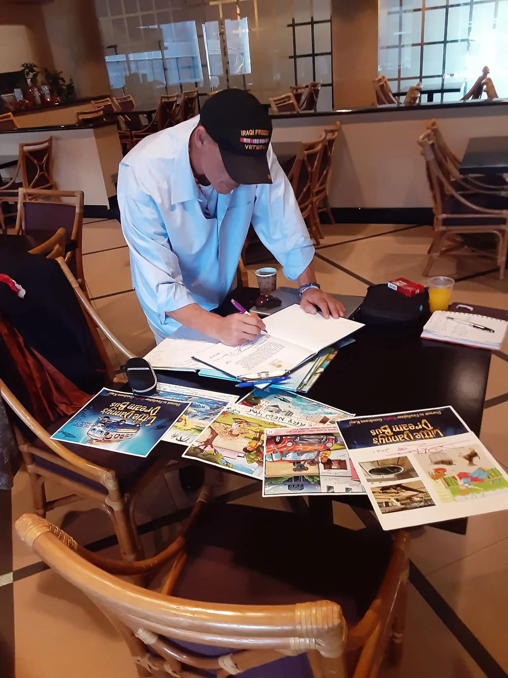 With his new book illustrations, author David Haave preparing for a book presentation to teach kids how to make their own book pages, TX, USA.